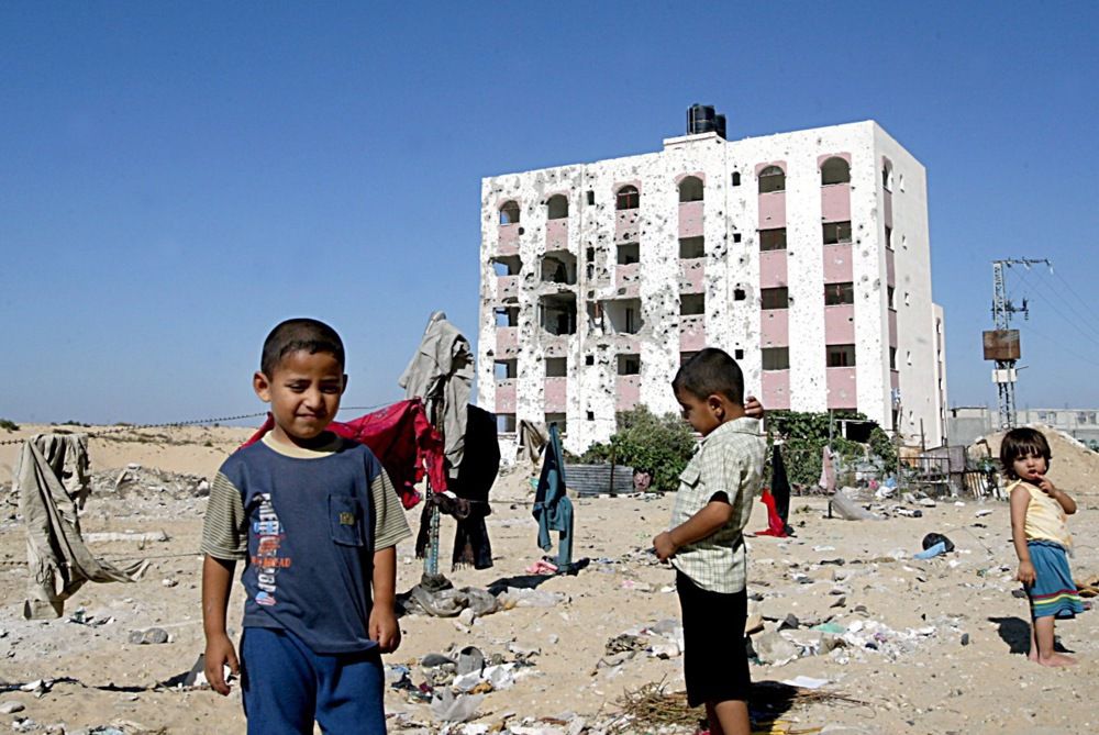 Palestinian childrens playing near a destoyed bulding at the refugee camp, EPA/ALI ALI
