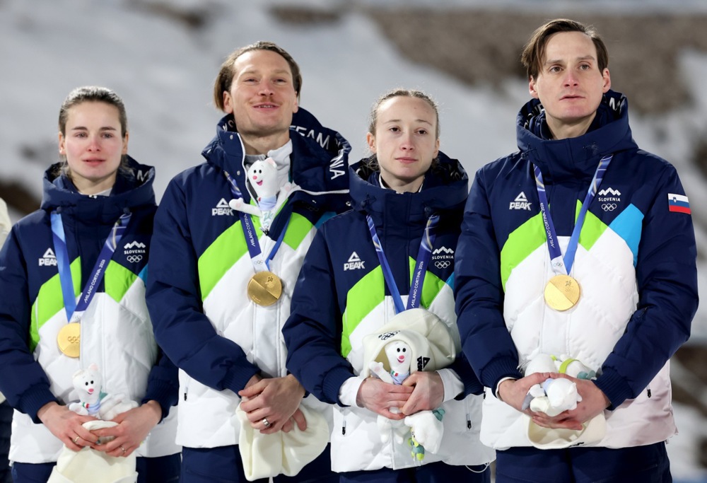 epa12724860 Gold medalists Team Slovenia (from L) Nika Vodan, Anze Lanisek, Nika Prevc and Domen Prevc and Anze Lanisek listen to the Slovenian national anthem during the medal ceremony for the Mixed Team Normal Hill of the Ski Jumping competitions at the Milano Cortina 2026 Olympic Games, in Predazzo, Italy, 10 February 2026. EPA/FILIP SINGER